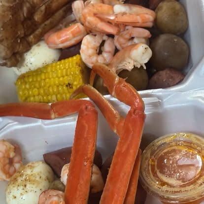 Tray of boiled shrimp with corn on the cob and potatoes