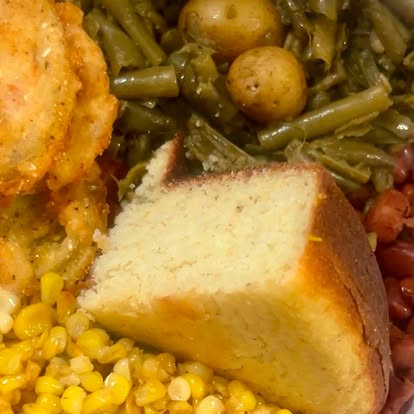 Fried chicken plate with cornbread, greens and corn